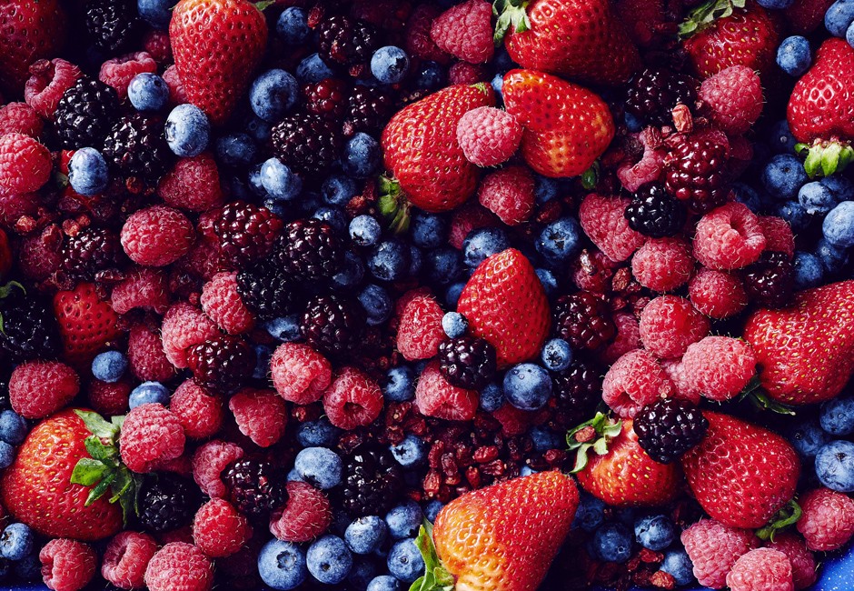 Still life with abundance of strawberries, blackberries, blueberries, raspberries and cranberries