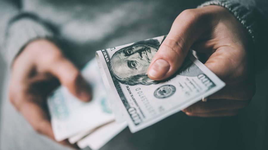 Подросток держит в руках доллары